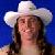 HBK wearing a cowboy hat on a blue background.